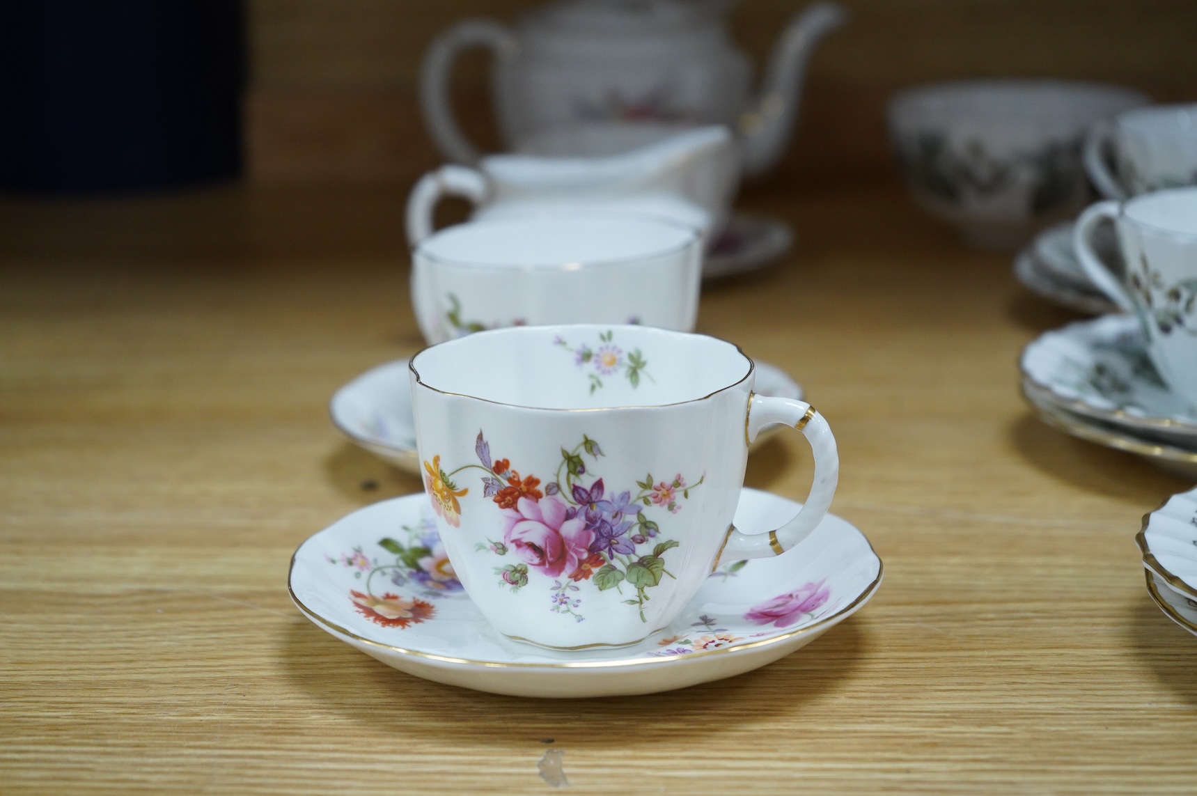 A Royal Crown Derby tea for two set, and a Royal Worcester Lavinia pattern part tea set to include trios, largest 20cm wide